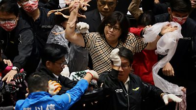 Taiwan lawmakers throw pork intestines at each other during a scuffle in the parliament in Taipei, Taiwan