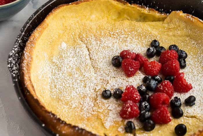 dutch baby pancake in skillet with berries