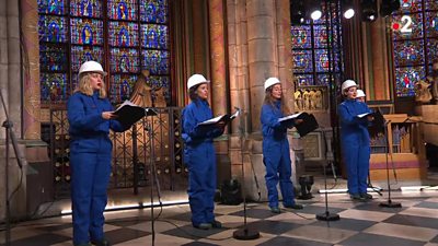Choir singers perform inside Notre-Dame cathedral