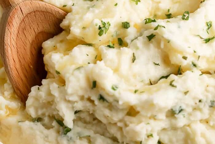 Horseradish Mashed Potatoes in a bowl with a wooden spoon