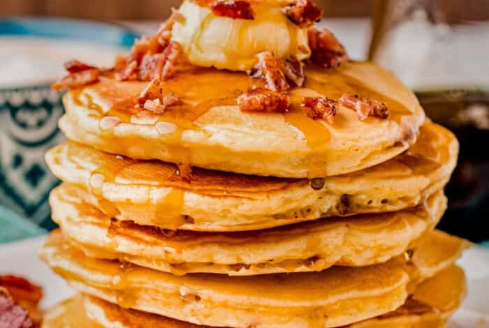 pile of Bacon Pancakes with syrup and bacon on top