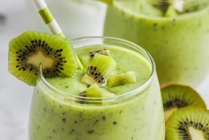 Kiwi Smoothie in a glass with pieces of kiwi as garnish