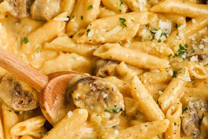 Stove Top 3 Cheese Pasta with Sausage with a wooden spoon