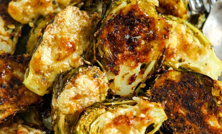 Parmesan Brussel Sprouts in a bowl with utensils