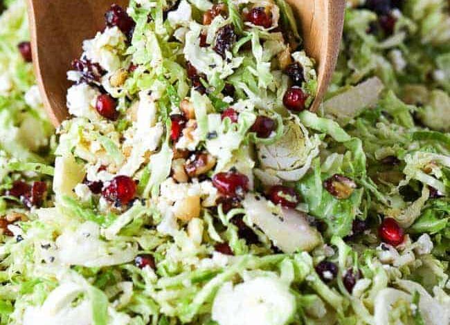 brussels sprout salad with cranberries and feta being served