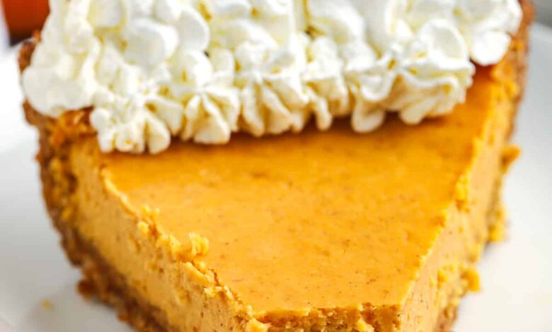 a slice of pumpkin cheesecake with a bite