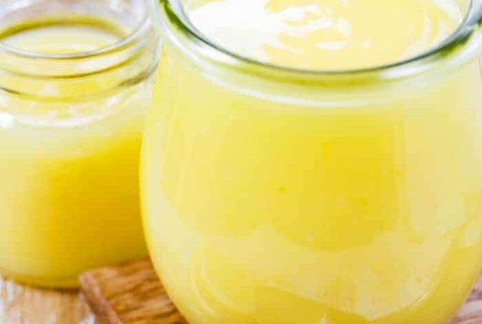 Lemon curd in a jar with a spoon