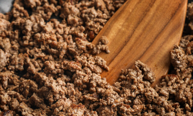 mixing cooked beef to show How to Brown Ground Beef