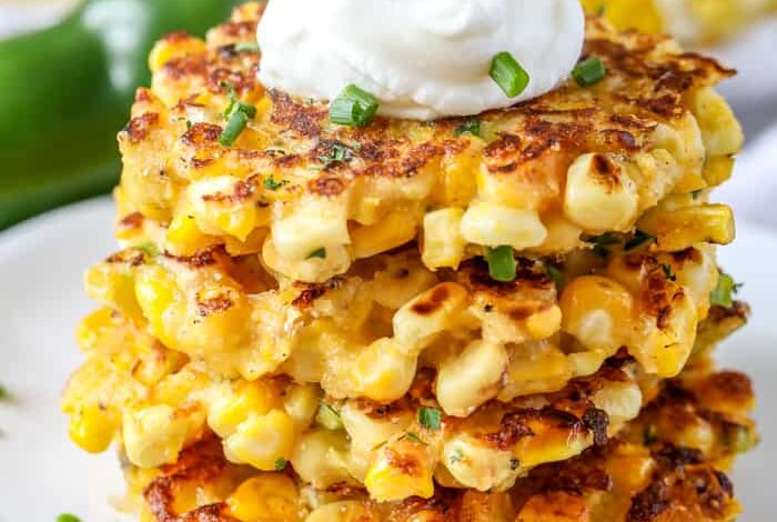 Four Corn Fritters Stacked on a Plate