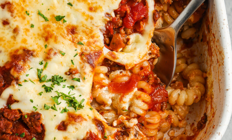 baked ground beef casserole in a dish with a spoon