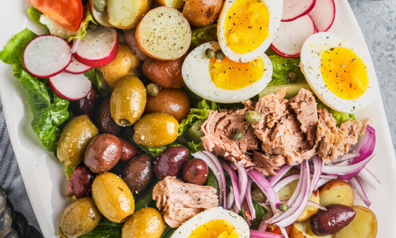 Nicoise Salad in a dish with a spoon beside it