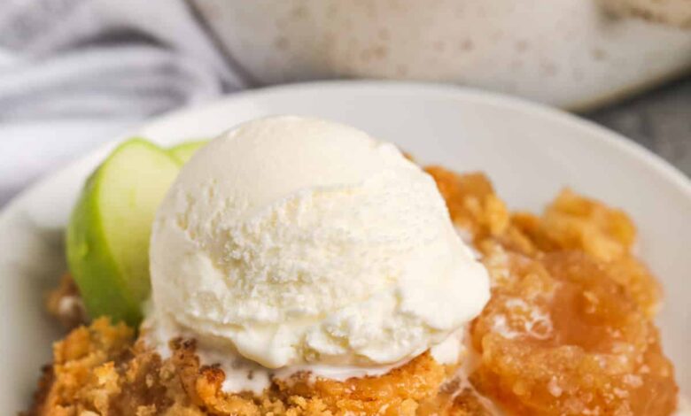 Apple Dump Cake on a plate with ice cream and apples