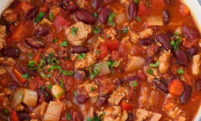 turkey chili in a pot with a bowl of cheese