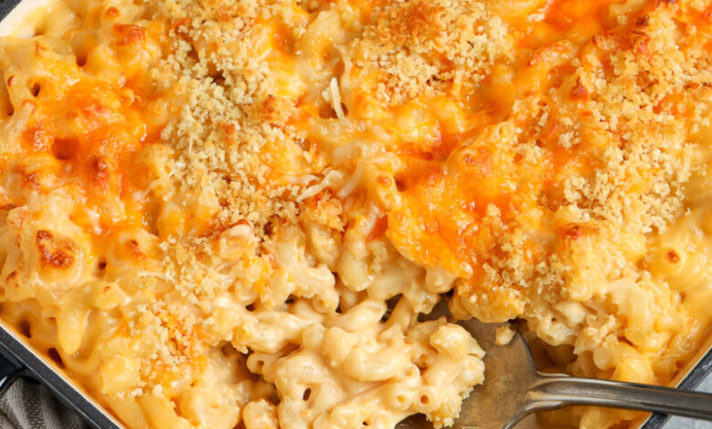 serving baked mac and cheese with a spoon