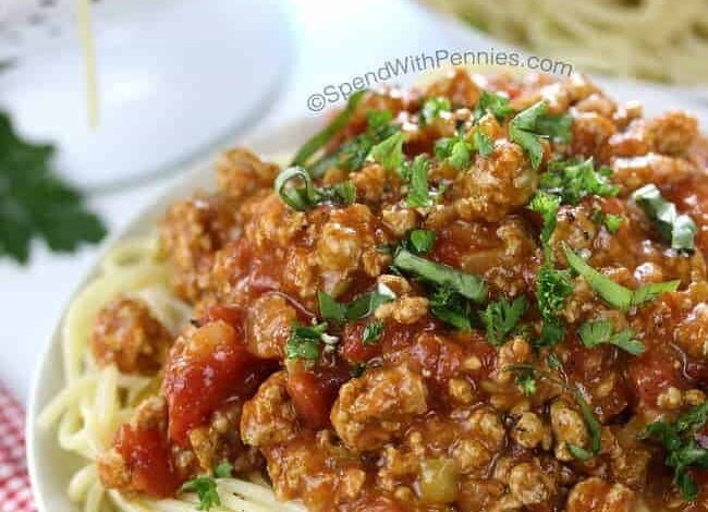 Cooked spaghetti on a plate with homemade pasta sauce on top