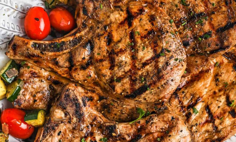 cooked Grilled Pork Chops with vegetables on a plate