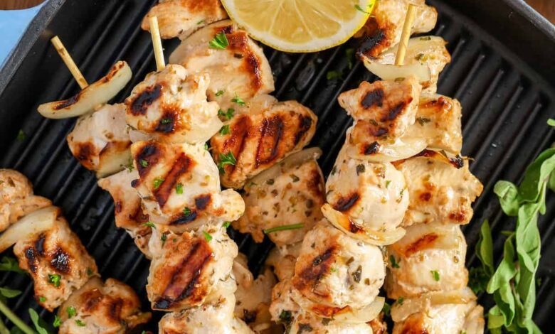 cooked chicken souvlaki on a grill pan