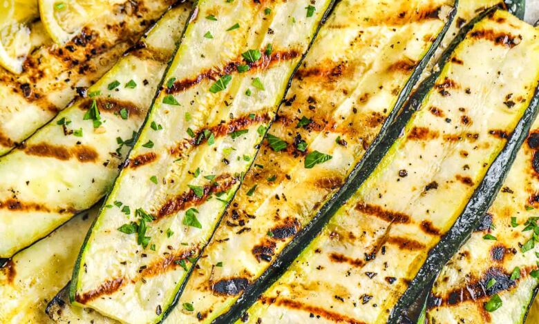 a plate of grilled zucchini with lemon slices