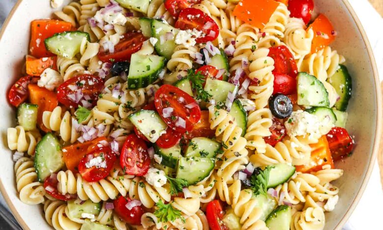 an an easy pasta salad in a white serving bowl with parsley