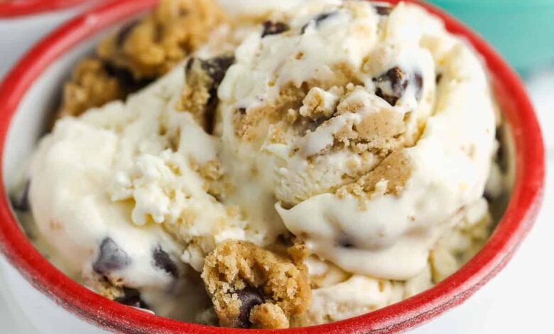 a bowl of homemade cookie dough ice cream with cookie dough in the background
