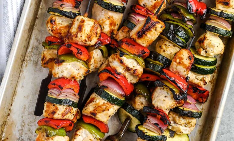 cooked greek chicken kabobs on a metal tray