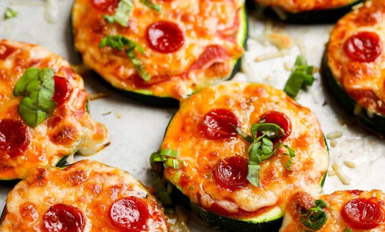 zucchini pizza bites on a pan with basil on top