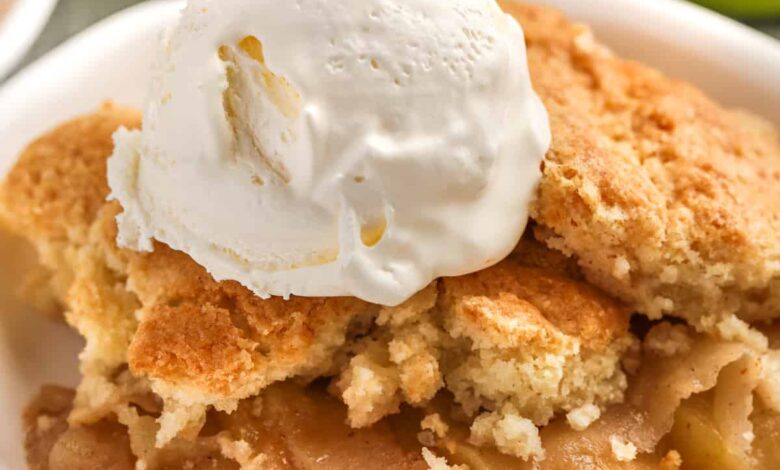 Apple cobbler topped with ice cream in a bowl