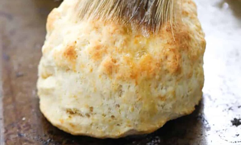 brushing butter on Homemade Biscuits