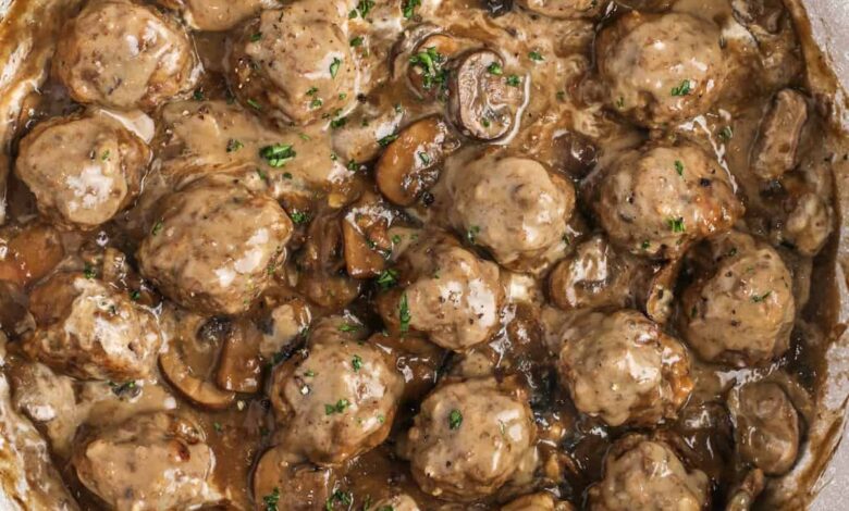 Meatballs in mushroom sauce in a frying pan