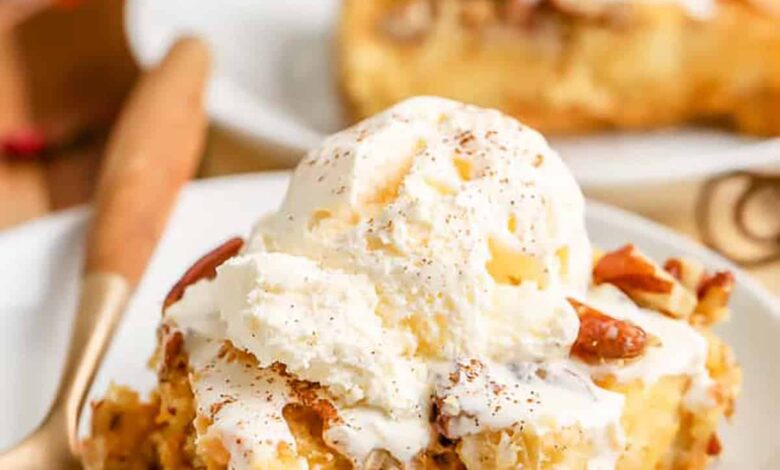 a slice of pumpkin crunch cake topped with ice cream