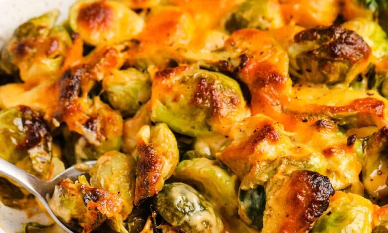 Baked Brussels Sprouts au Gratin in the dish with a spoon