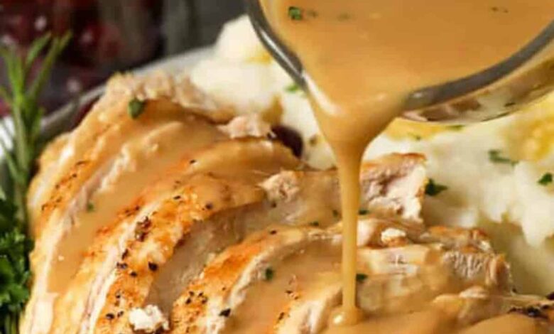 pouring gravy over plated Instant Pot Turkey Breast