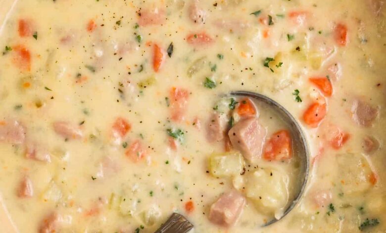 pot of Ham and Potato Soup with a spoon