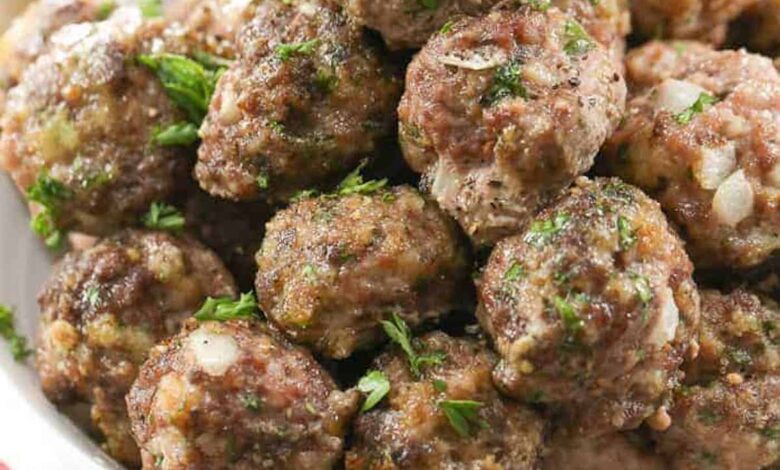 A plate filled with an easy meatball recipe topped with parsley.