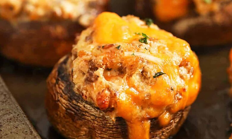 close up of Sausage Stuffed Mushrooms on a sheet pan
