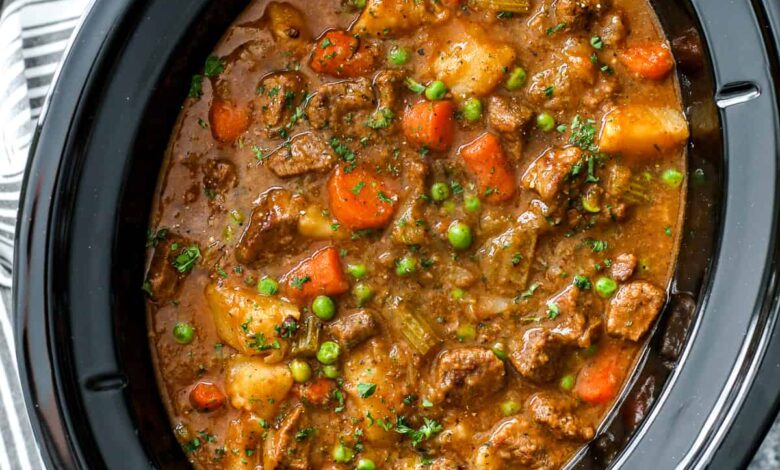 crockpot beef stew in a slow cooker garnished with parsley